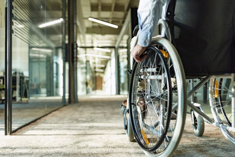 Man in wheelchair in hallway