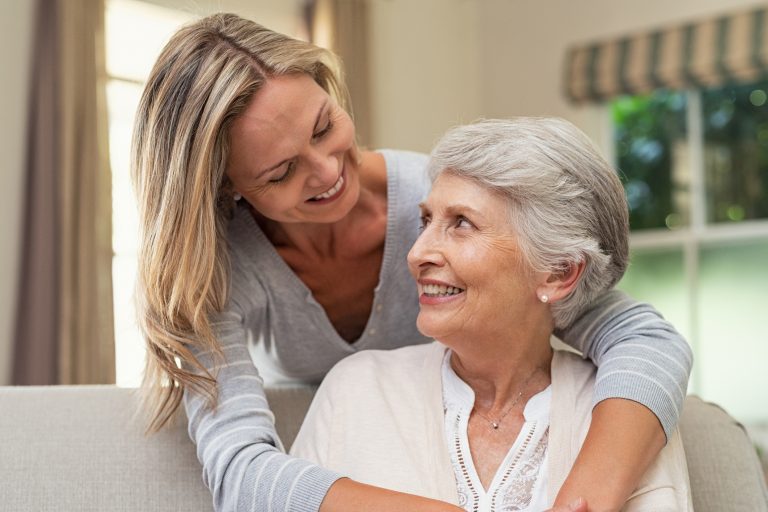 Woman embracing senior mother