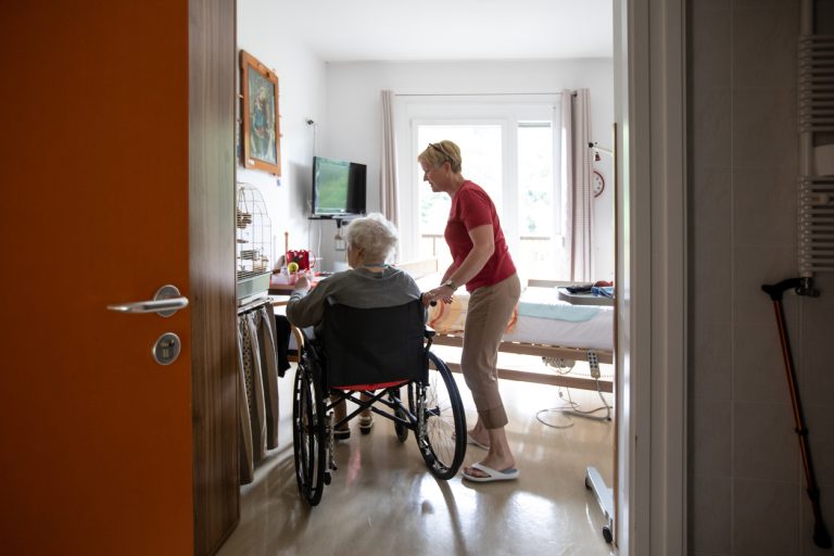 Caregiver and a senior woman in a wheelchair