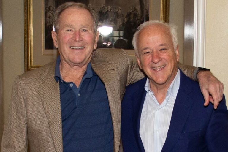 A photo of AWD founder and CEO Jim Towey smiling with his former boss, President George W. Bush.