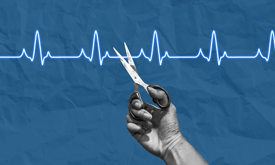 Blue background, light blue heartbeat line bisected by a black and white hand holding scissors set to cut the heartbeat line